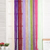 A vertical display of colorful thread curtains or tie-backs in various shades including purple, red, green, and pink.