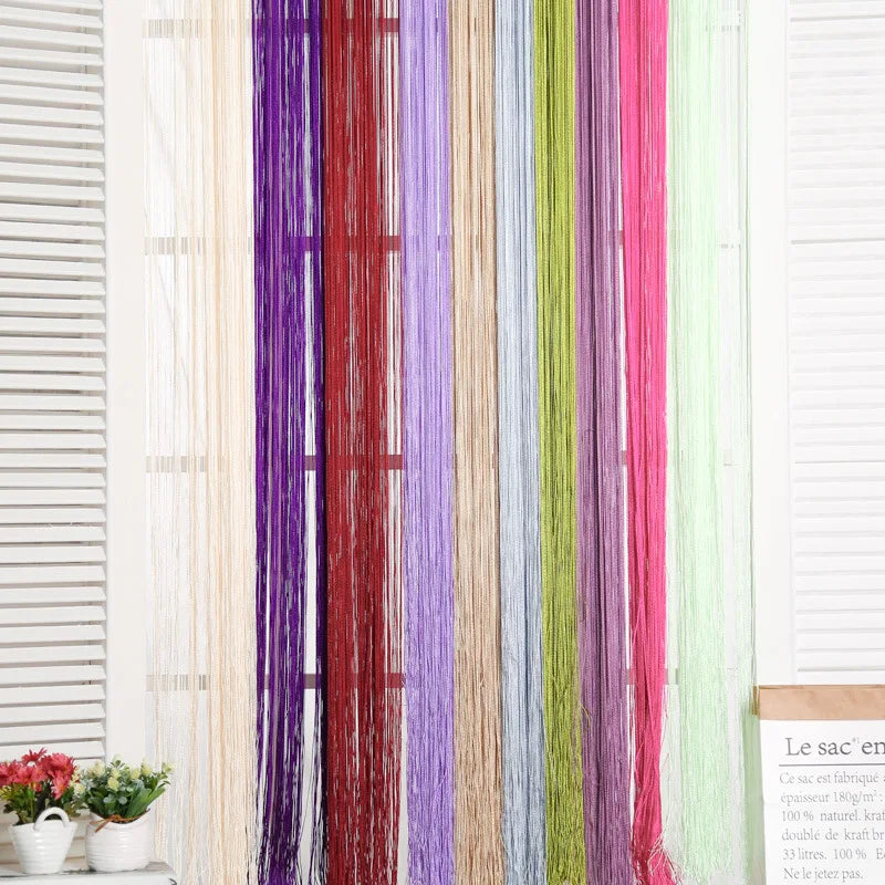 A vertical display of colorful thread curtains or tie-backs in various shades including purple, red, green, and pink.