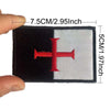 Black and white embroidered patch featuring a red cross on a flag design