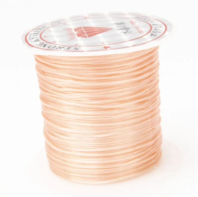 A spool of multicolor elastic beading cord with a decorative label.