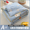 A lightweight summer quilt with a cartoon pattern featuring small bear shapes, folded and displayed on a white surface.
