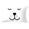 A white decorative pillow cover featuring a minimalist black cat face design.