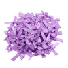 A pile of light purple satin ribbon bows for craft and decoration.