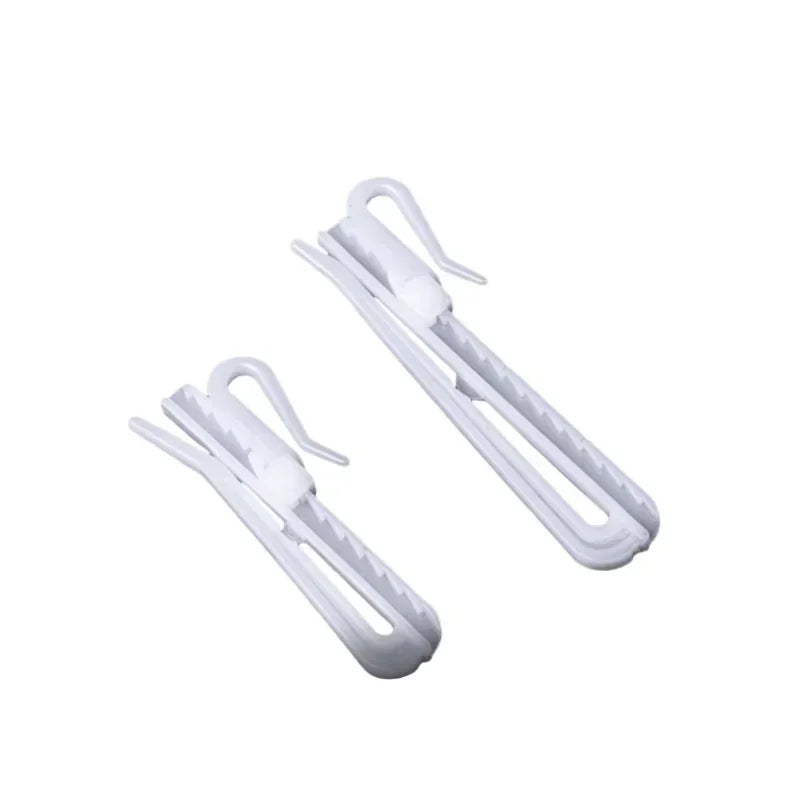 A set of white adjustable curtain hanging hooks for drapery installation.