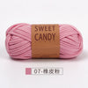 A skein of pink sweet candy yarn is shown lying horizontally against a white background.