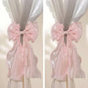 A pair of pink sheer ribbon bow curtain tiebacks displayed against a white background.