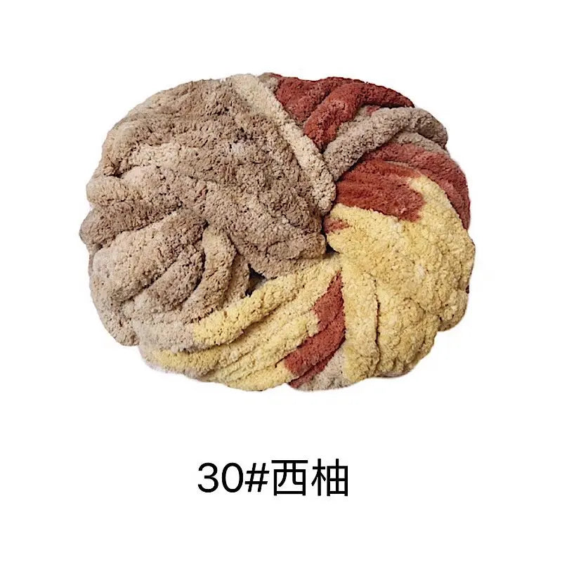 A ball of hand-woven chunky chenille yarn featuring mixed shades of brown, beige, and reddish-orange.