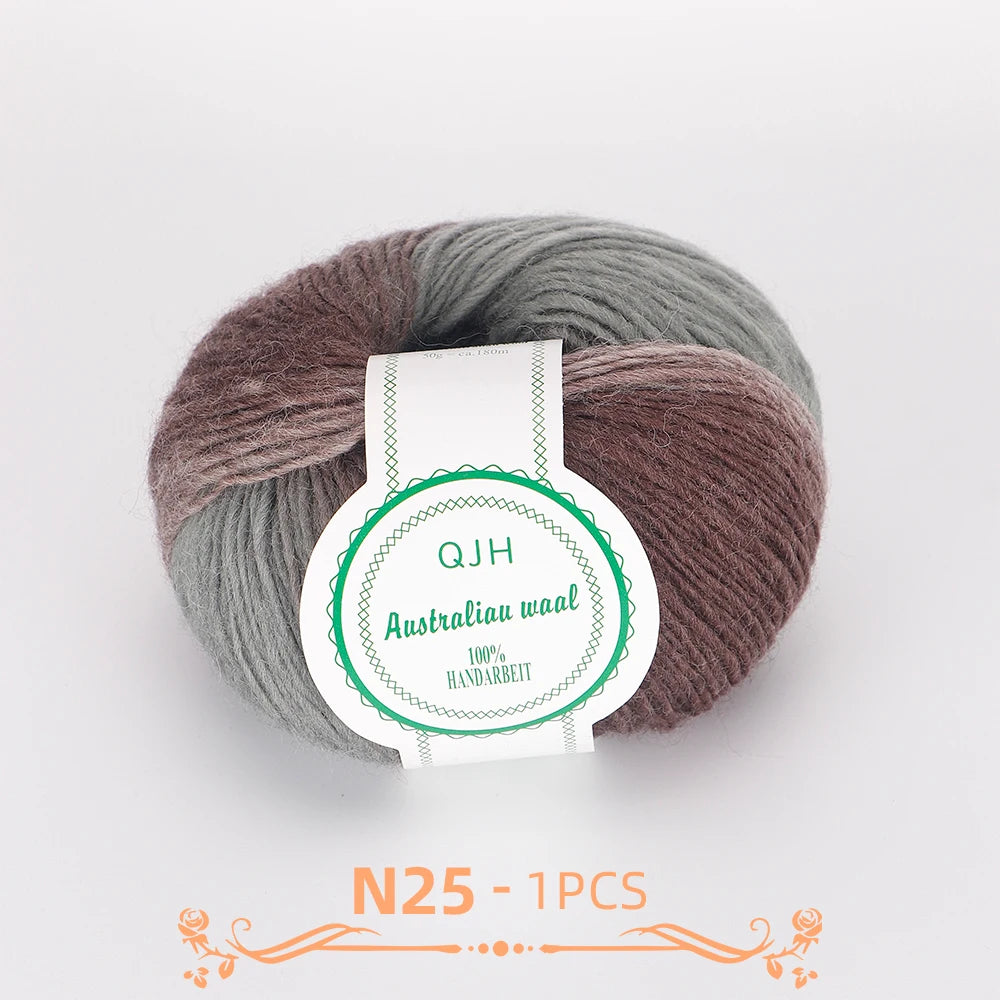 A ball of multi-colored wool yarn, featuring shades of grey and brown, with a label indicating QJH Australia waal.