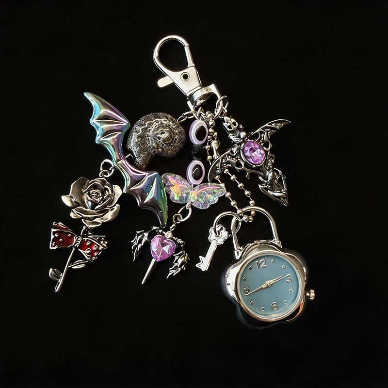 Silver and purple star-shaped keychain featuring a pocket watch and various charms.