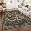 A dark gray area rug with a beige snake print pattern in a living room setting.