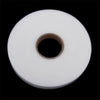 Roll of white double-sided fabric interlining tape with a central hole