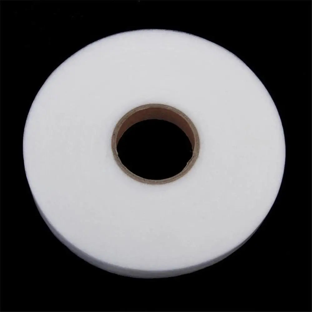Roll of white double-sided fabric interlining tape with a central hole