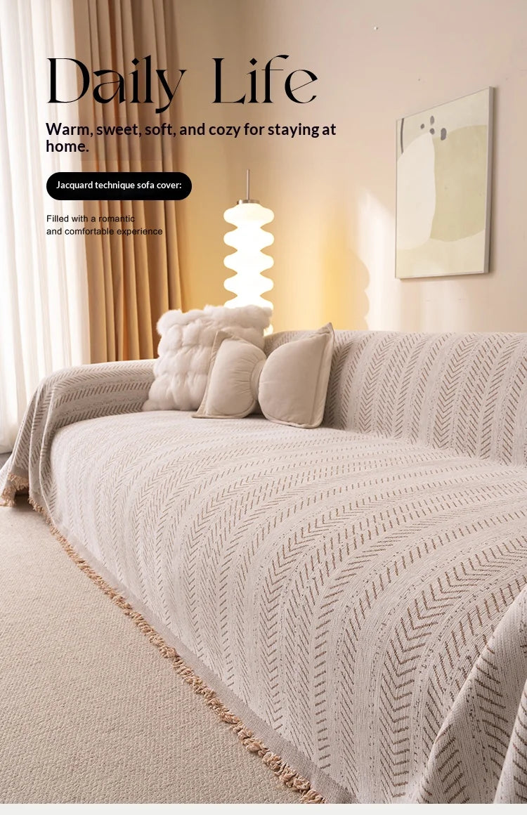 A cozy bedroom scene featuring a bed covered with a beige quilted fabric and soft pillows, next to a lamp.