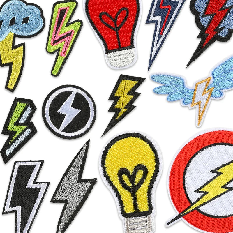 A collection of embroidered lightning bolt and lightbulb patches in various colors like blue, green, red, and yellow.