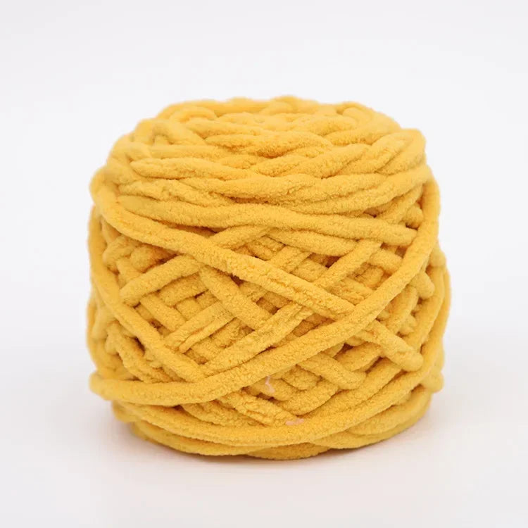 A ball of bright yellow chenille knitting yarn used for hand crafting.