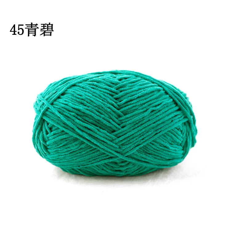 A ball of teal green chenille yarn used for knitting and crochet projects.