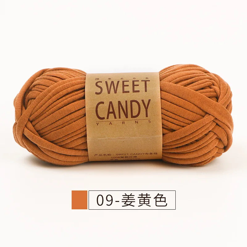 A ball of hand-dyed, warm orange-brown yarn labeled Sweet Candy Yarns for crochet and knitting.