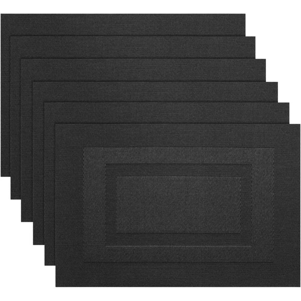 A set of six black non-slip heat resistant placemats stacked in a row.