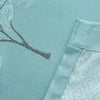 Light blue fabric featuring a delicate black line drawing of branches and leaves.