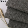 Stack of dark gray coarse linen and cotton fabric rolls