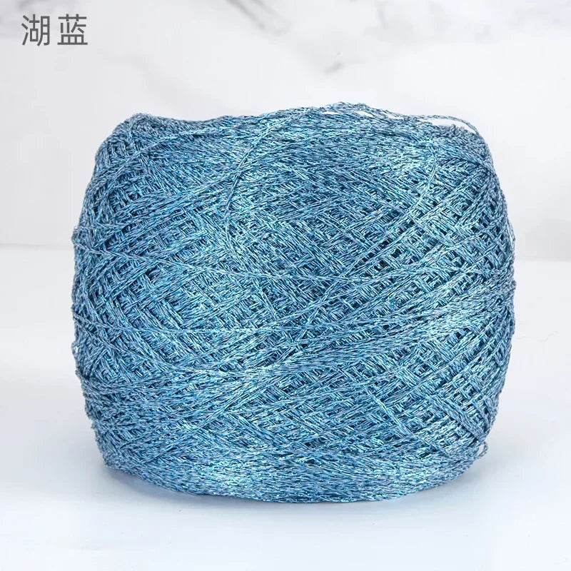 A ball of metallic blue silk yarn used for crocheting and knitting.