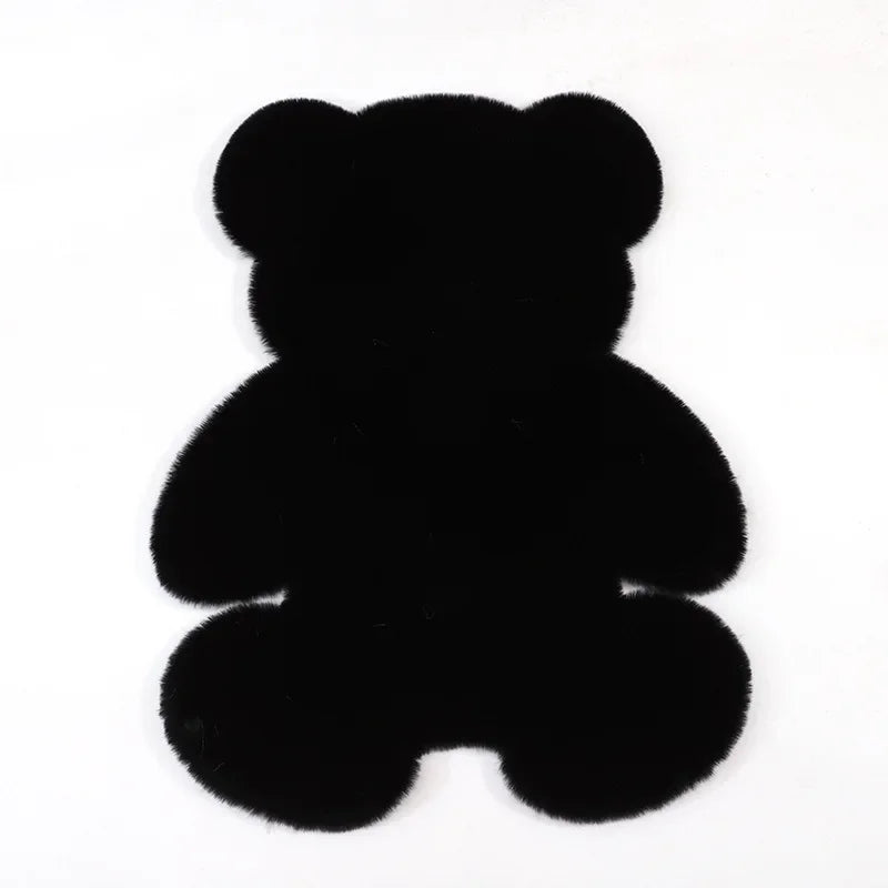 A black plush bear-shaped non-slip area rug.