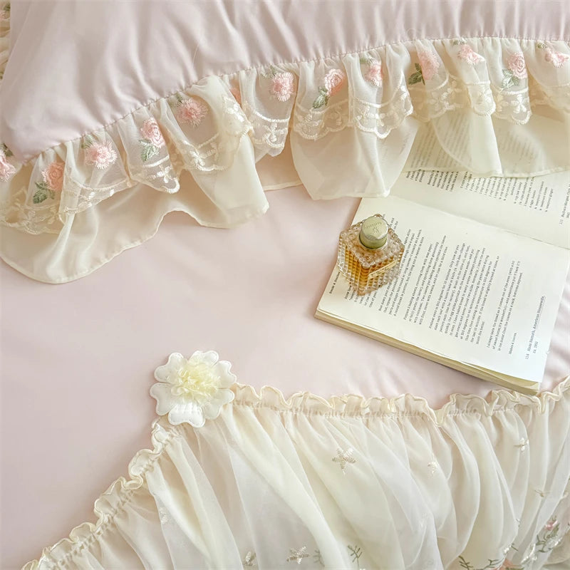 A close-up of a light pink Korean style lace embroidered duvet set featuring sheer fabric and floral details.