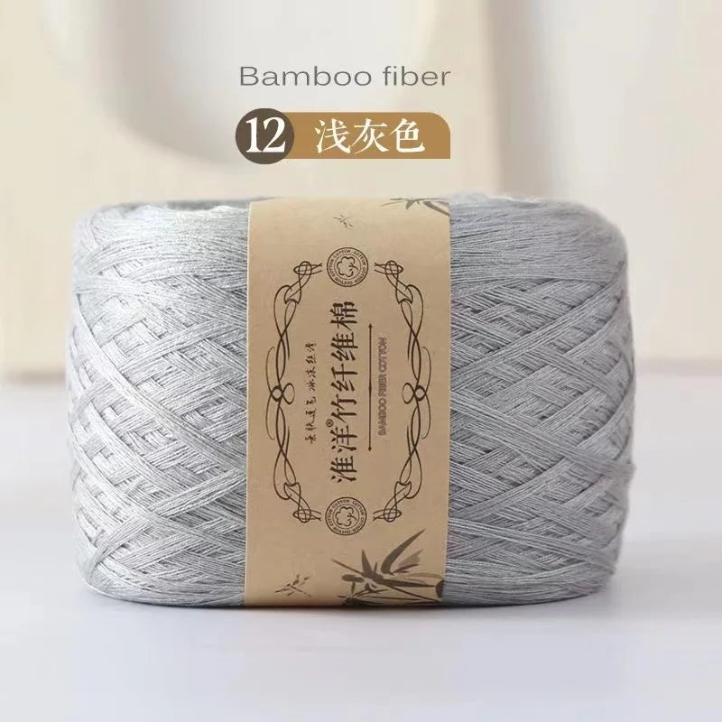 A skein of gray bamboo fiber yarn is shown, packaged with a label indicating 12 colors.