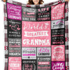 A women models a large pink and black patterned throw blanket featuring text about Grandma and blessings.