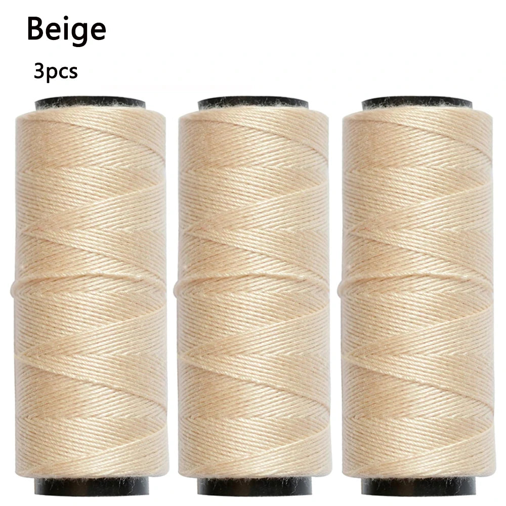 Three beige spools of sewing thread, 3 pieces included.
