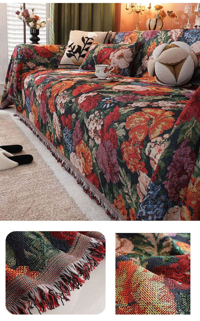 A richly colored floral jacquard sofa throw blanket draped over a sofa with decorative pillows.