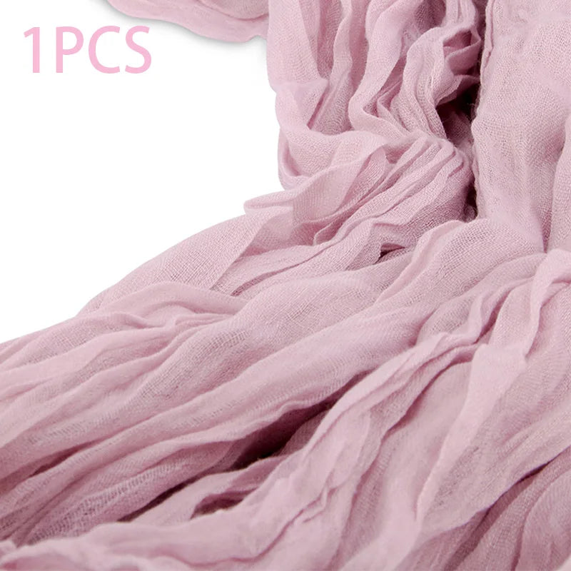 A light pink semi-sheer gauze fabric draped in soft folds.