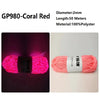 Spool of bright coral red polyester yarn for knitting and crochet