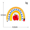 A yellow, blue, and orange rainbow patch with a red apple in the center, measuring 6.9cm by 8.2cm.