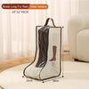 A beige boot storage bag with a brown carry handle and clear plastic lining is shown on a light rug.