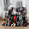 A dark flannel throw blanket featuring a collage of retro printed photographs and faces.