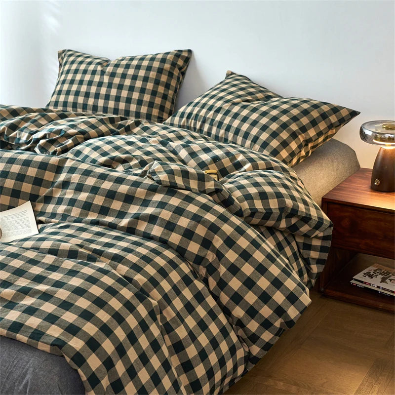 A dark green and beige plaid duvet cover set with matching pillows on a bed.