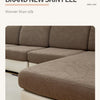 A close-up of a textured, taupe sofa cushion cover featuring a delicate leaf pattern.