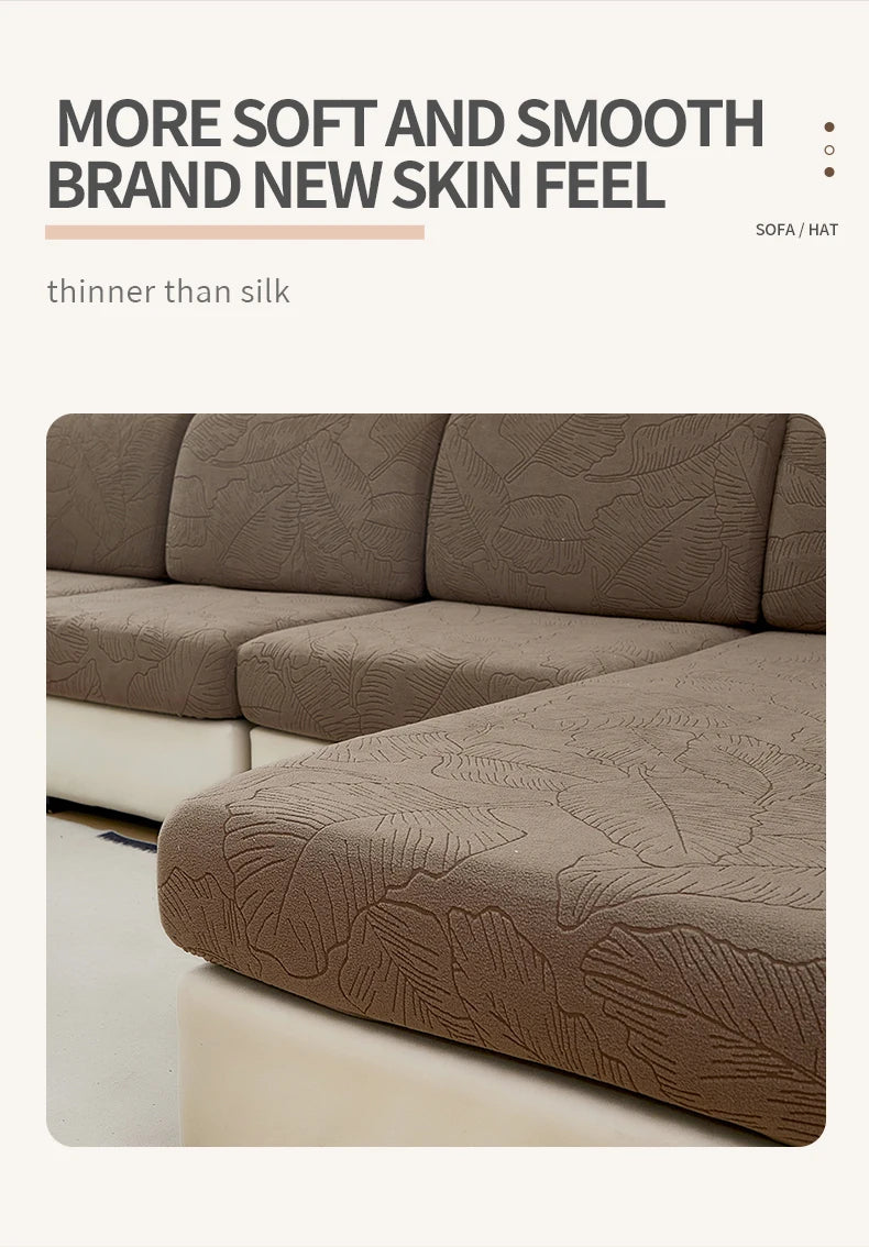 A close-up of a textured, taupe sofa cushion cover featuring a delicate leaf pattern.