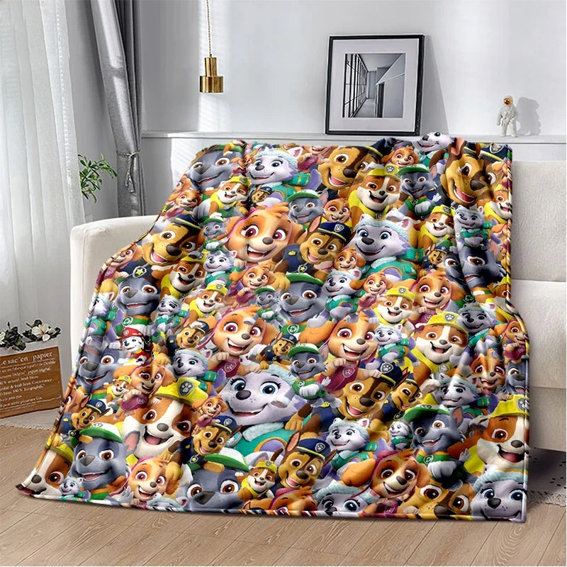 A colorful flannel throw blanket featuring a pattern of cartoon dog plush characters.