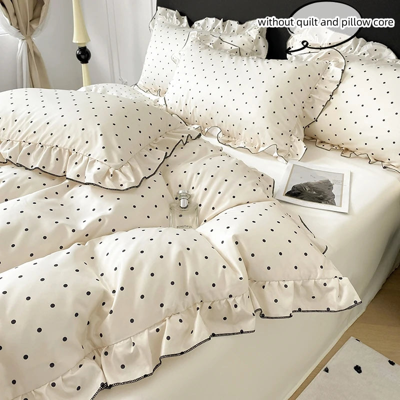 A set of white Korean lace duvet covers and pillow covers with black polka dots displayed on a bed.