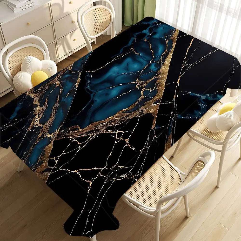 A black marble table cloth featuring blue and gold veining displayed on a wooden floor with white chairs.