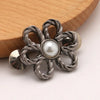 Silver adjustable metal waist clips shaped like flowers with pearl accents