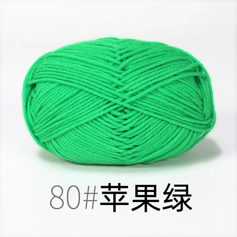 A ball of bright green organic cotton 4ply knitting yarn for crafts.