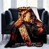 A dark horror themed throw blanket featuring a close-up of Michael Myers.