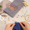 A gray storage case for an aluminum circular needle set with spare needles and a yellow cord, next to knitting hands working 