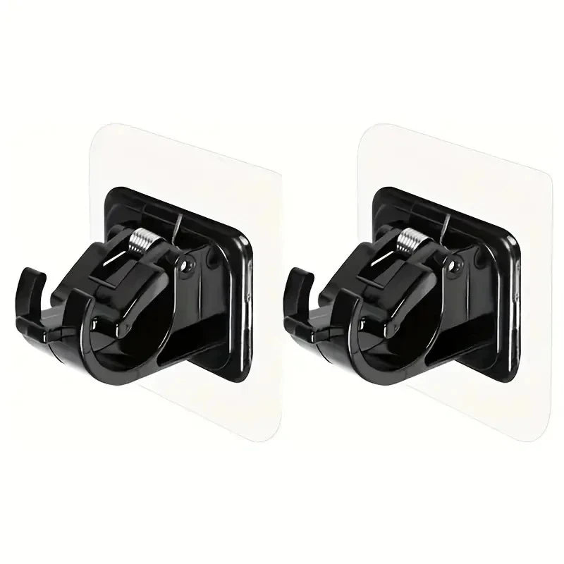 Two black no drill adhesive curtain rod brackets for mounting hardware.