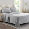 A gray luxury microfiber bed sheet set featuring a duvet cover and pillowcases on a bed with a upholstered headboard.
