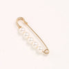 A delicate gold-toned adjustable pearl necklace with a thin chain and several round pearls.