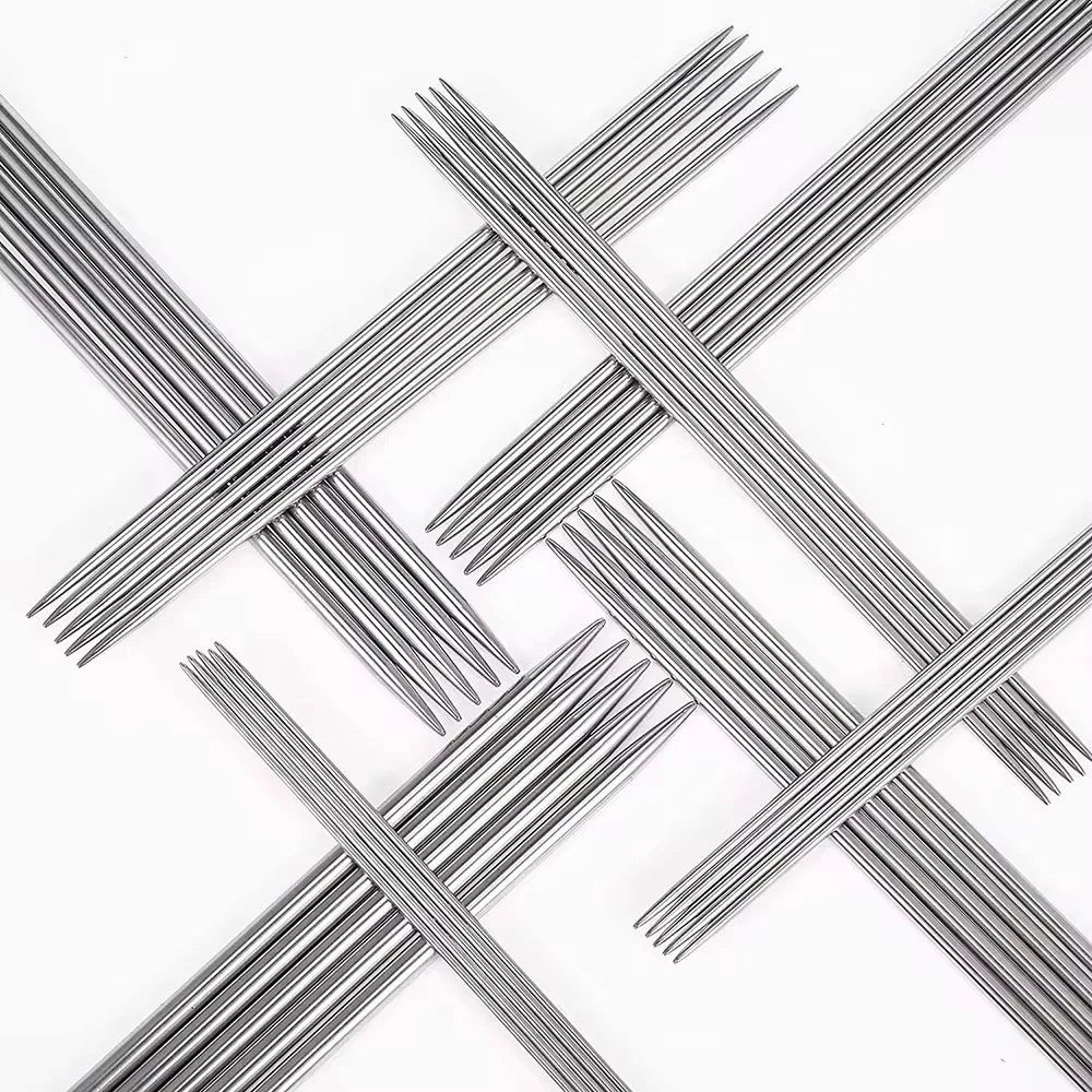 A set of stainless steel double-pointed knitting needles crossed in an 'X' pattern.